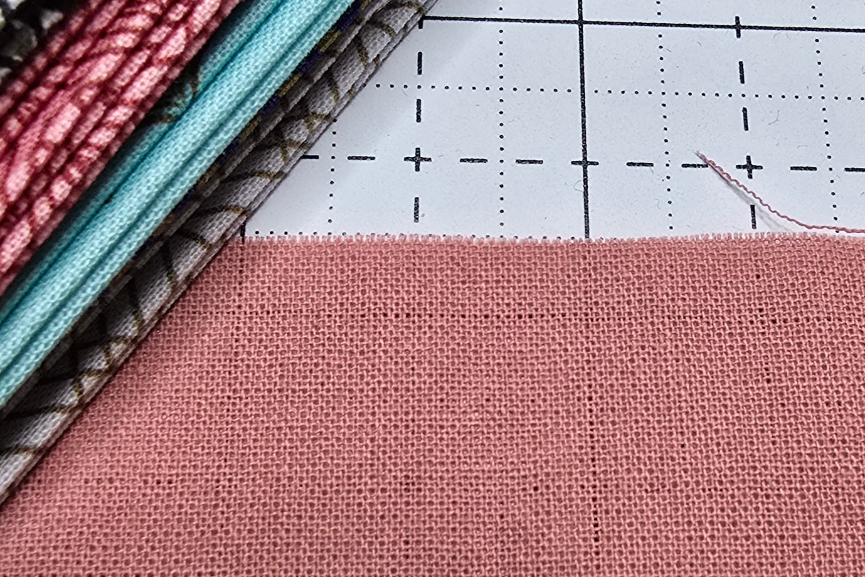 Beth is showing a fabric cut along the grains of the fabric