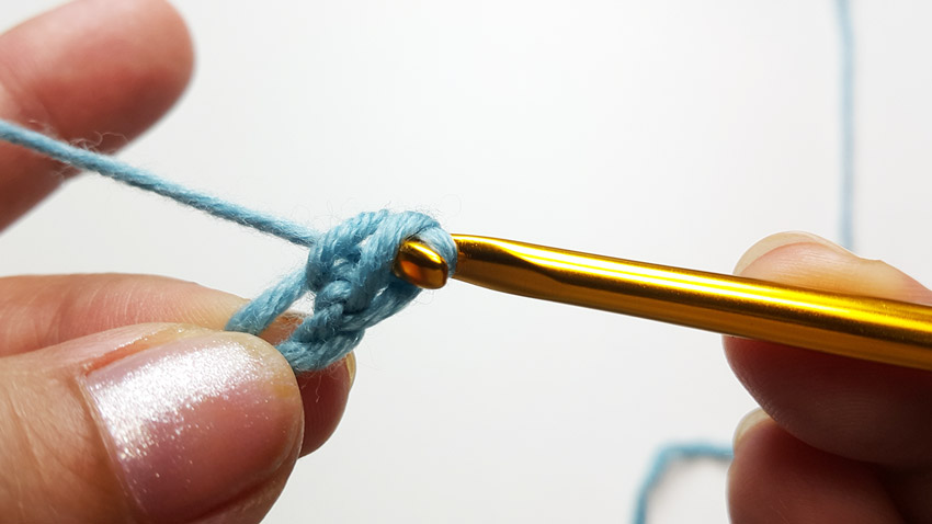 Pulling yarn through two loops