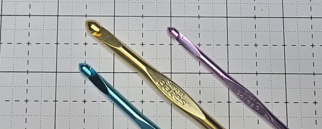 Elizabeth is showing Susan Bates crochet hooks are made with light aluminium