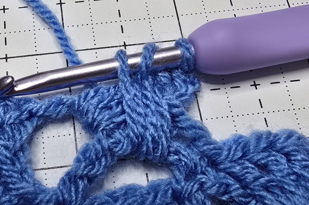 The act of overlapping another shell stitch