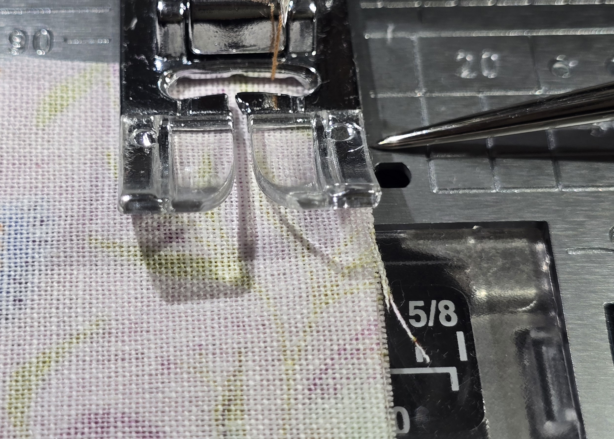 Beth is showing fabric placement against Janome standard foot and straight stitch plate to sew the quarter inch allowance on sttich number 7