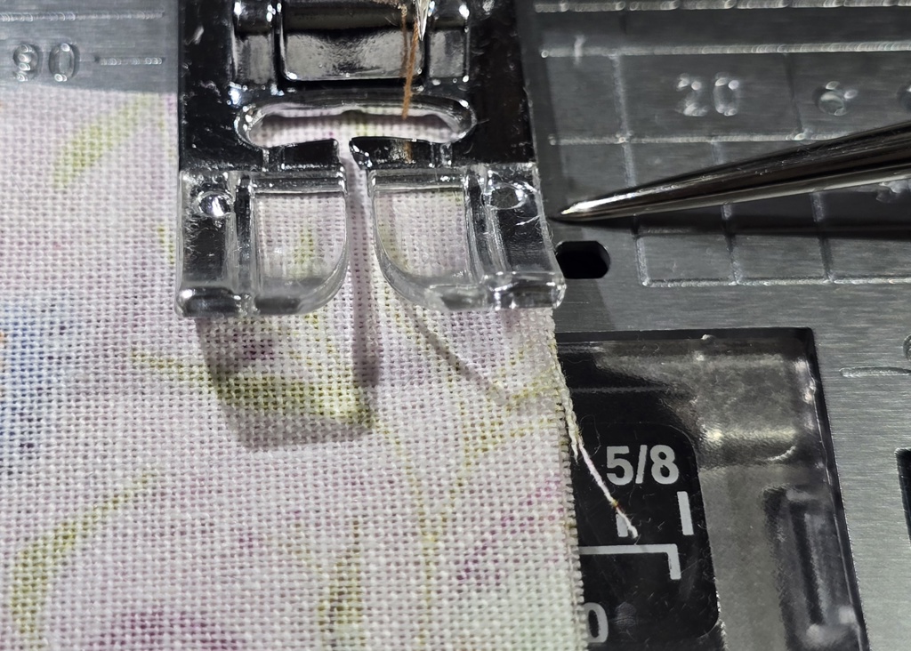 Beth is showing fabric placement against Janome standard foot and straight stitch plate to sew the quarter inch allowance on sttich number 7
