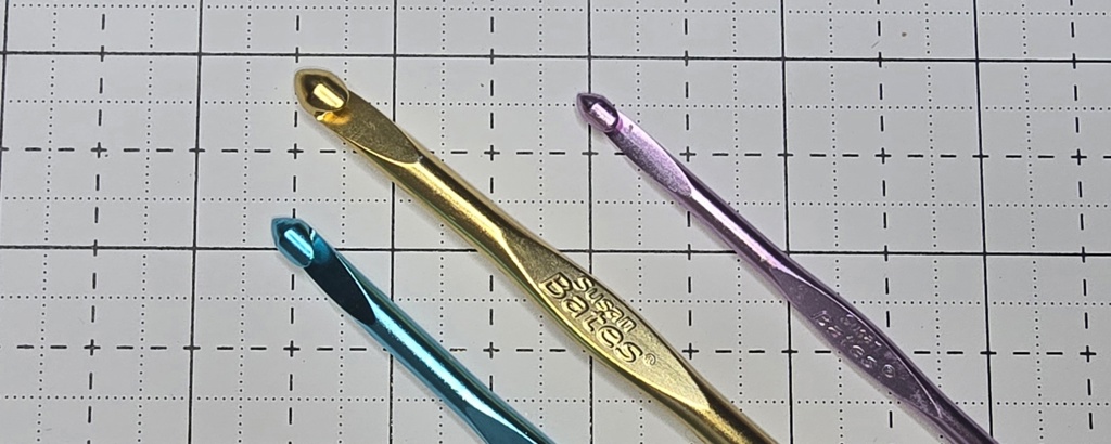 Elizabeth is showing Susan Bates crochet hooks are made with light aluminium